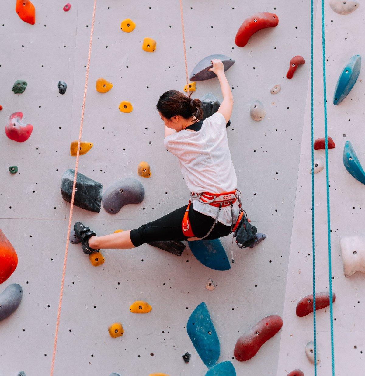 Woman climbing on an obstacle wall